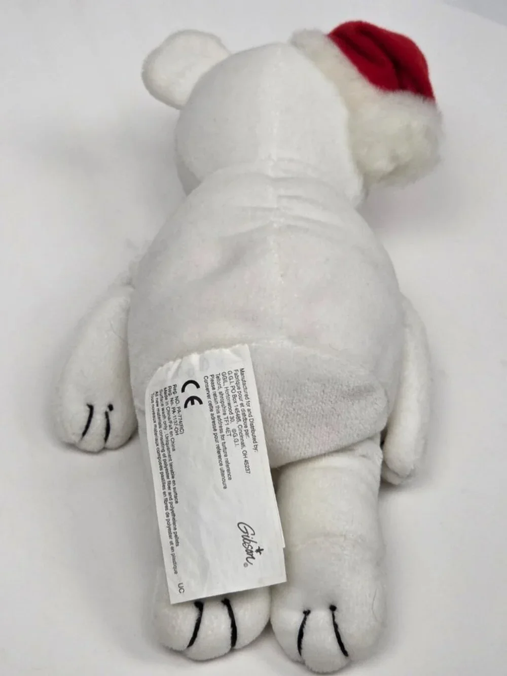 white plush holiday teddy bear wearing a small red Santa hat 8